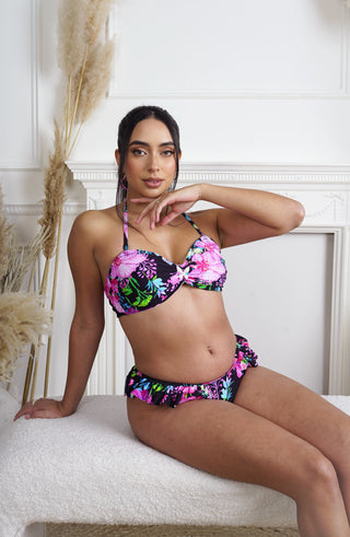 Woman wearing a colorful butterfly themed floral bikini 